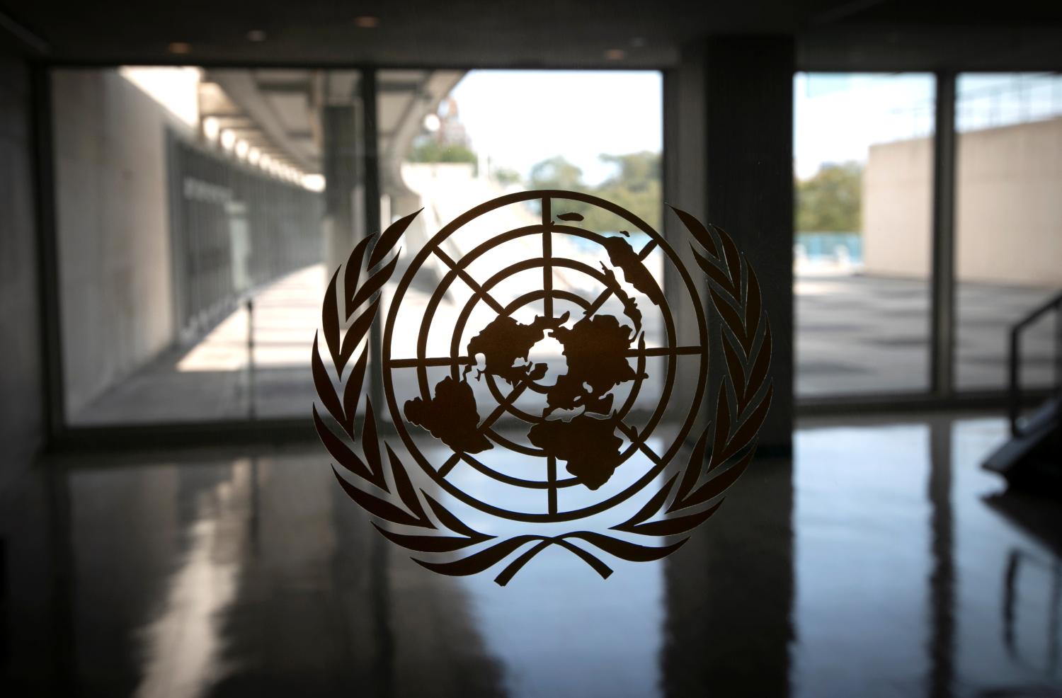 The United Nations logo is seen on a window in an empty hallway at United Nations headquarters during the 75th annual U.N. General Assembly high-level debate, which is being held mostly virtually due to the coronavirus disease (COVID-19) pandemic in New York, U.S., September 21, 2020. REUTERS/Mike Segar