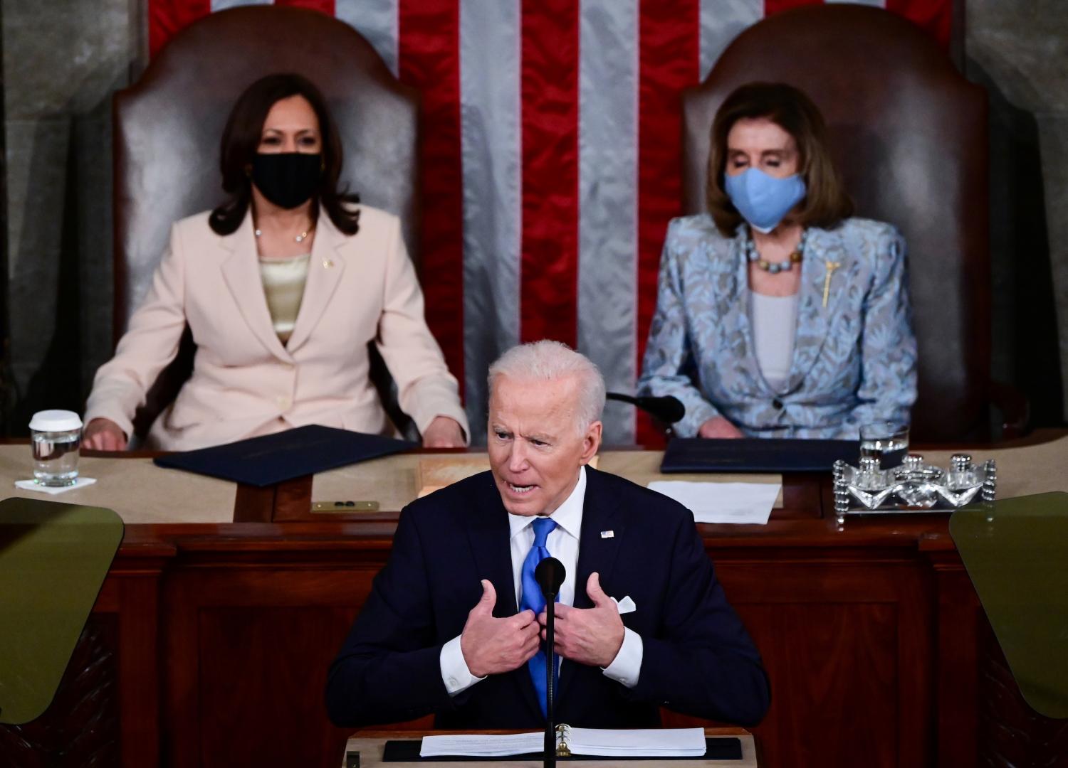 U.S. Vice president Kamala Harris and Speaker of the House Nancy Pelosi listen as U.S. President Joe Biden addresses to a joint session of Congress in the House chamber of the U.S. Capitol in Washington, U.S., April 28, 2021.  Jim Watson/Pool via REUTERS