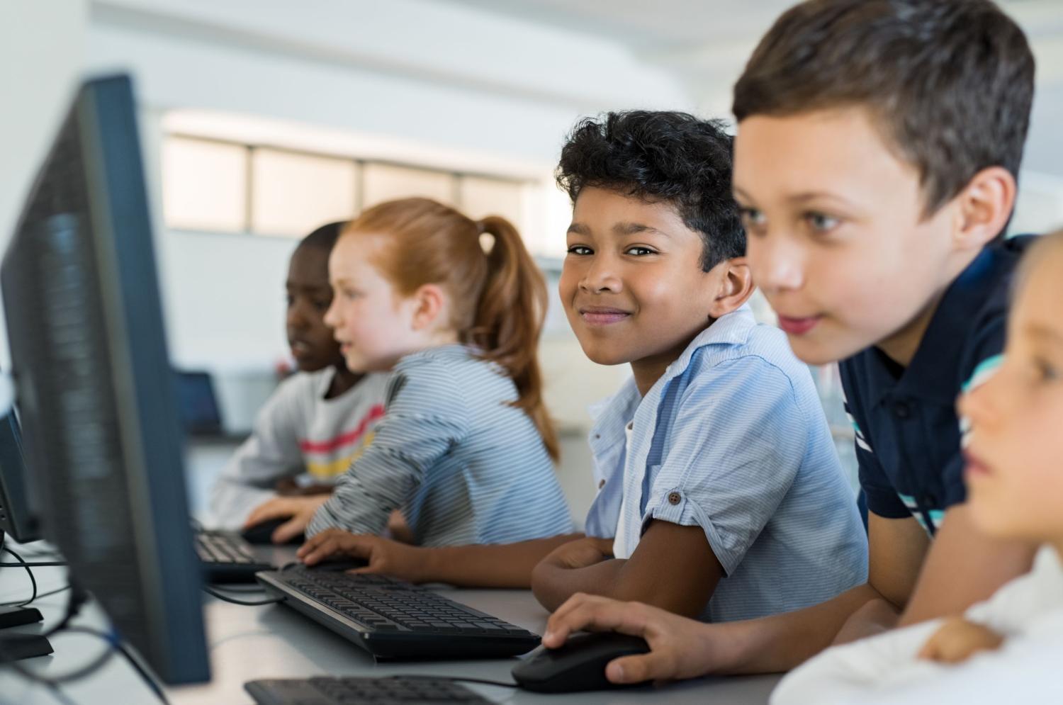 Students sit at a computer in British Columbia.