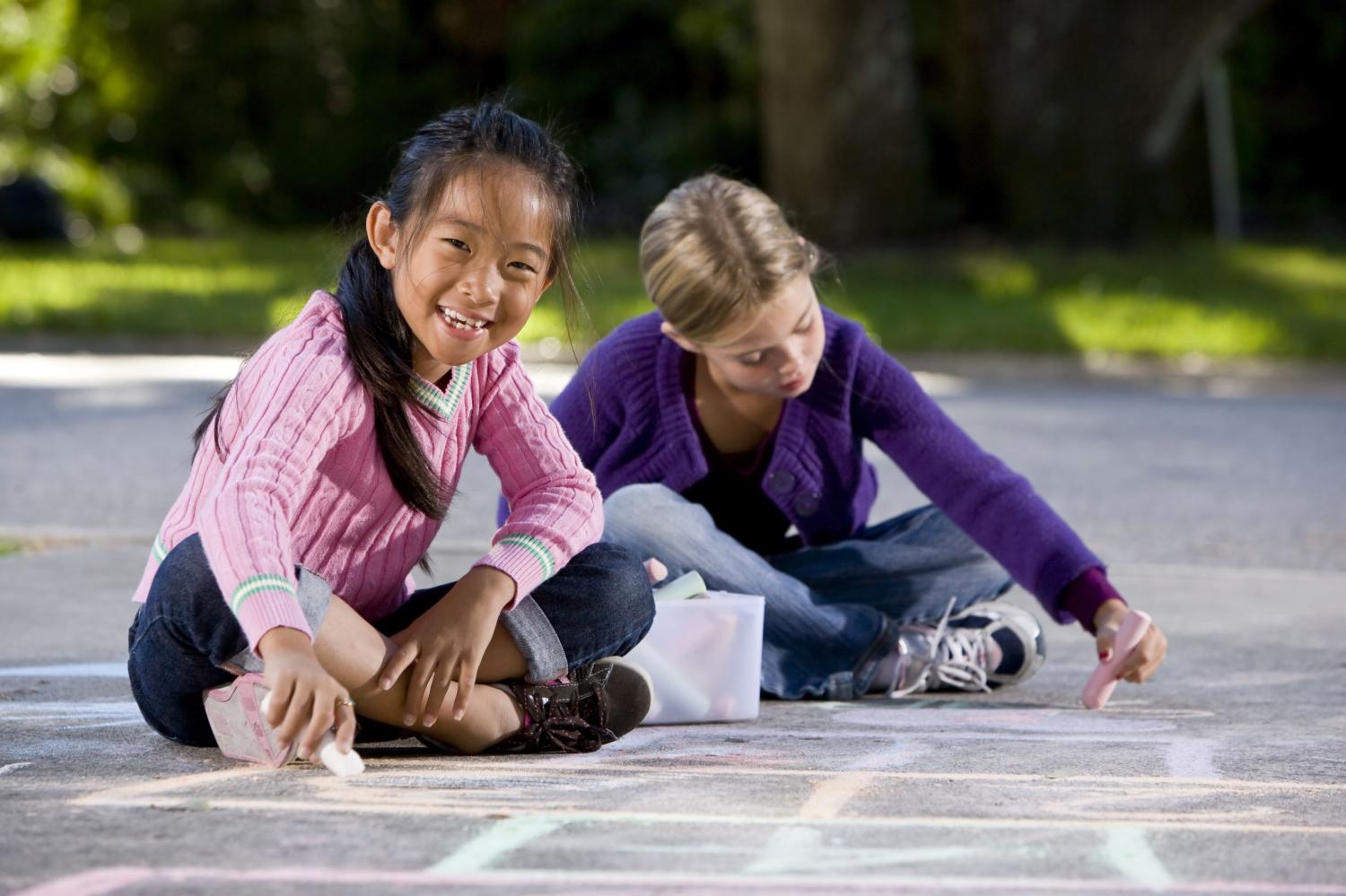 Children draw on the sidewalk.