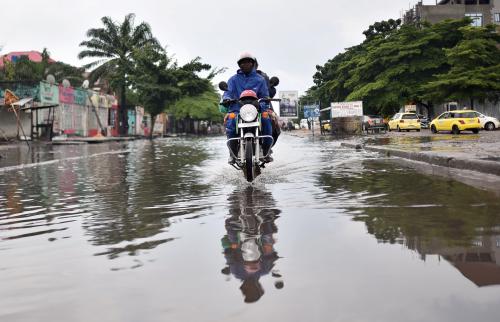 A motorcyclist rides through a flooded road during the presidential election in Kinshasa, Democratic Republic of Congo, December 30, 2018. REUTERS/Olivia Acland