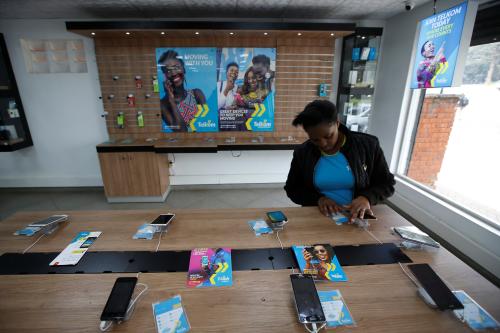 An employee of Telkom Kenya looks at a display stand at the company's shop in Nairobi, Kenya, July 27, 2018. REUTERS/Baz Ratner