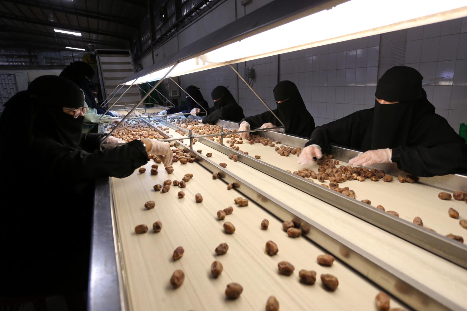 Saudi women work at a dates packaging factory in Al-Ahsa, Saudi Arabia, September 10, 2020. Picture taken September 10, 2020. REUTERS/Ahmed Yosri