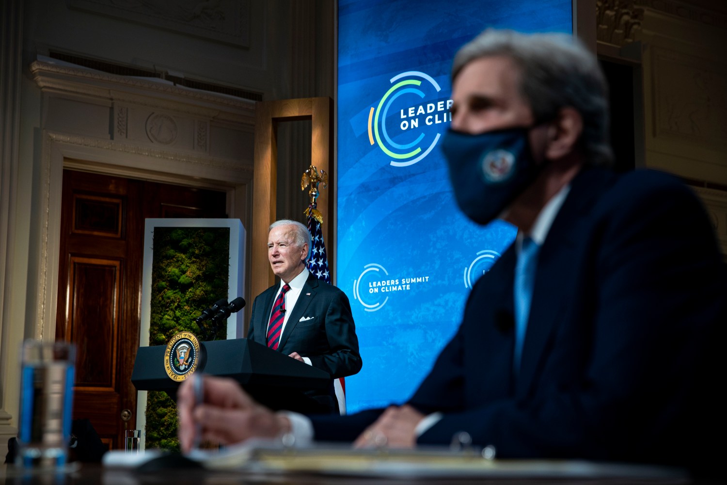 President Joe Biden speaks as Special Presidential Envoy for Climate John Kerry listens during a virtual Leaders Summit on Climate, in the East Room of the White House, on Thursday, April 22, 2021 in Washington. (Al Drago for Pool/Sipa USA) No Use Germany.