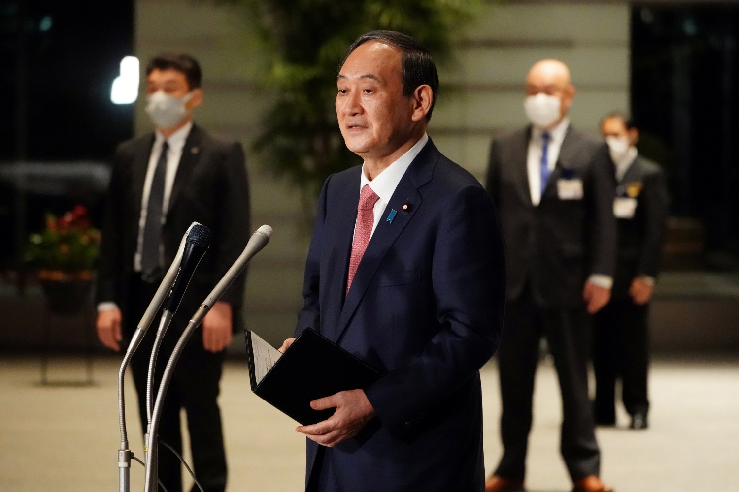 Japanese Prime Minister Yoshihide Suga speaks to media after announcing that Tokyo, Kyoto and Okinawa will have pre-emergency status under a new prevention law during a government task force meeting at the prime minister's office, Tokyo, Japan, April 9, 2021. Eugene Hoshiko/Pool via Reuters