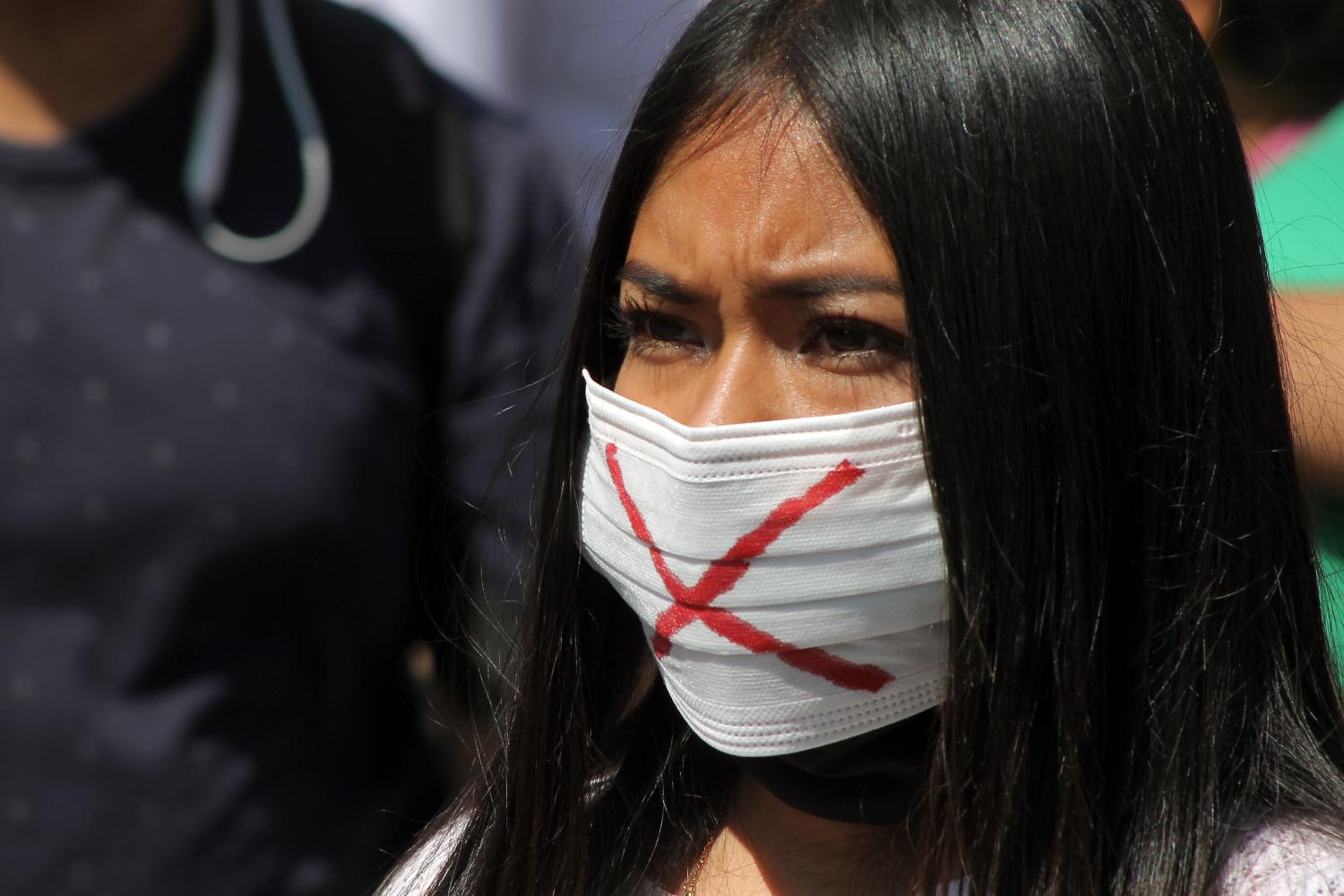 A woman wears a face mask with a X takes part during a protest in the historic center, demanding to the authorities resumption their works of Shop eyeglasses and optics on October 27, 2020 in Mexico City, MexicoWhere: Mexico City, MexicoWhen: 27 Oct 2020Credit: Eyepix/Cover Images