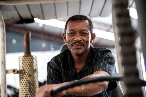 Worker on forklift looking at camera