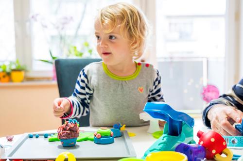 Child playing with modeling clay
