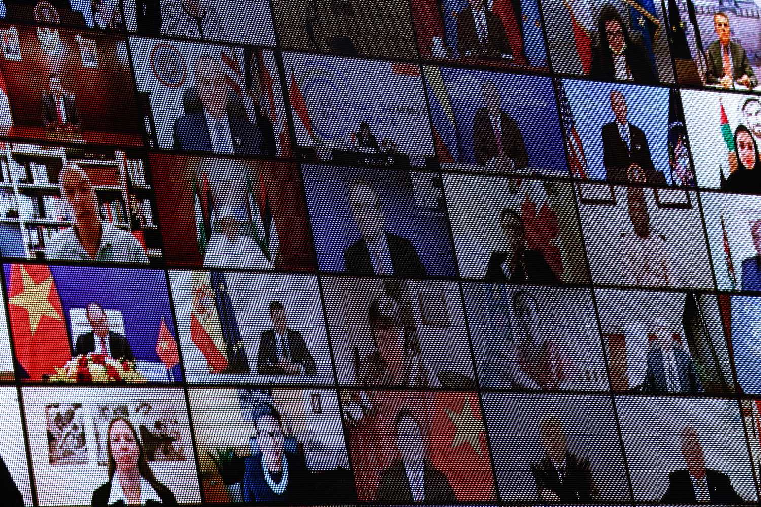 World leaders appear on a video screen during a virtual Climate Summit with world leaders in the East Room at the White House in Washington, U.S., April 23, 2021. REUTERS/Tom Brenner