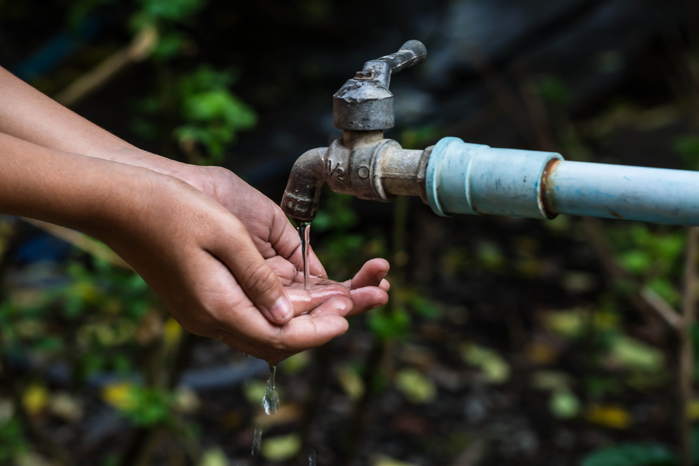 washing hands from water pipe