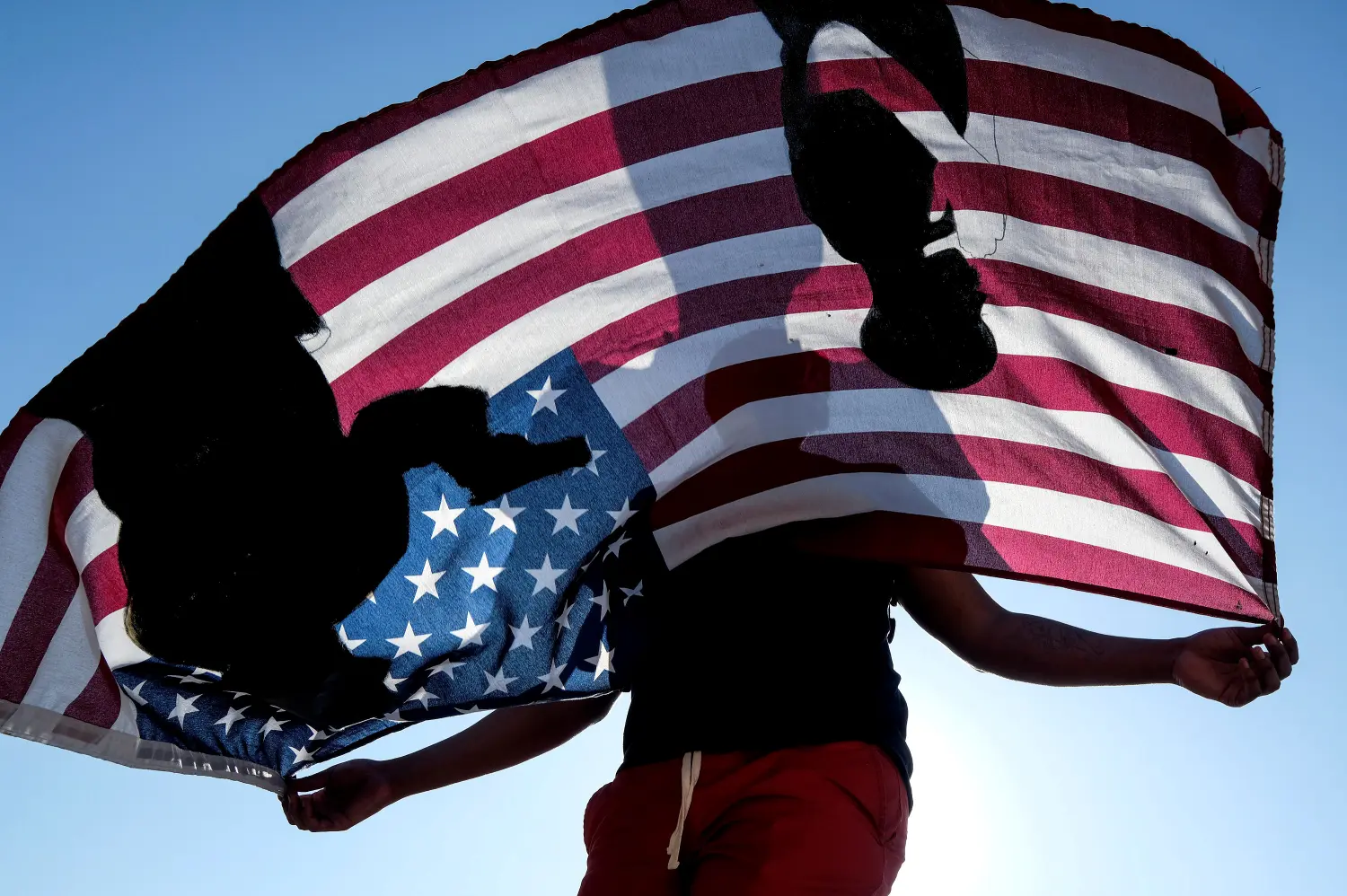 A demonstrator holds a flag during a protest against the death of 18-year-old Andres Guardado and racial injustice, in Compton, California, U.S., June 21, 2020. REUTERS/Ringo Chiu     TPX IMAGES OF THE DAY