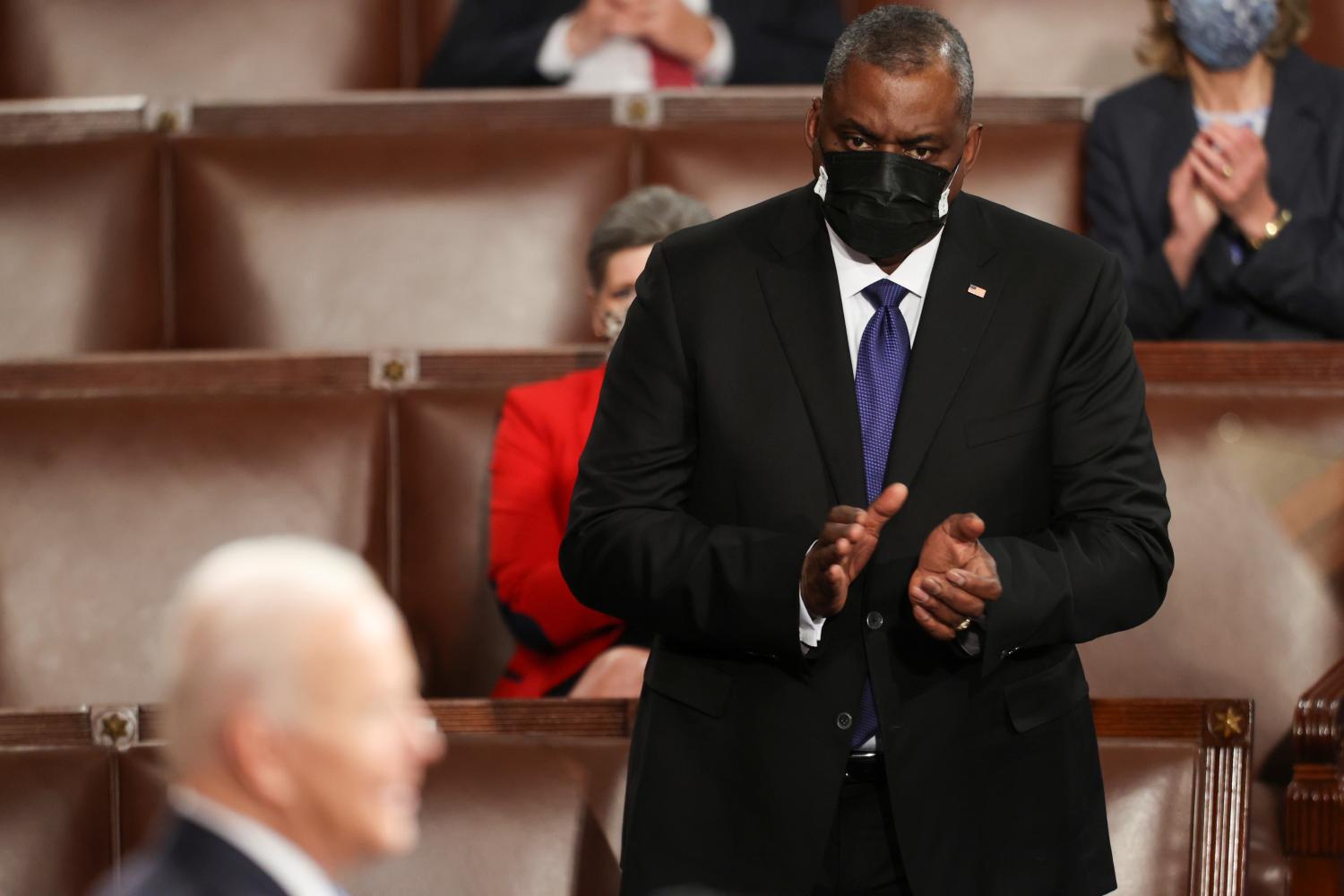 FILE PHOTO: U.S. Defense Secretary Lloyd Austin applauds U.S. President Joe Biden as Biden delivers his first address to a joint session of the U.S. Congress inside the House Chamber of the U.S. Capitol in Washington, U.S., April 28, 2021. REUTERS/Jonathan Ernst/Pool