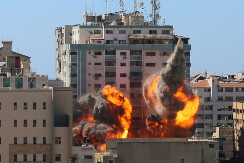 The al-Jalaa building housing Associated Press (AP) and Al Jazeera media offices is hit by an Israeli air strike in Gaza City, May 15, 2021. REUTERS/Ashraf Abu Amrah  NO RESALES. NO ARCHIVES.     TPX IMAGES OF THE DAY