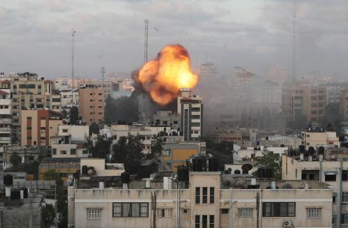 Smoke and flames are seen following an Israeli air strike on a building, amid a flare-up of Israeli-Palestinian fighting, in Gaza City May 18, 2021. REUTERS/Mohammed Salem