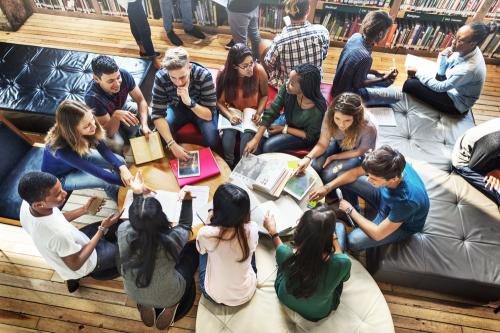 College students working together around a table.