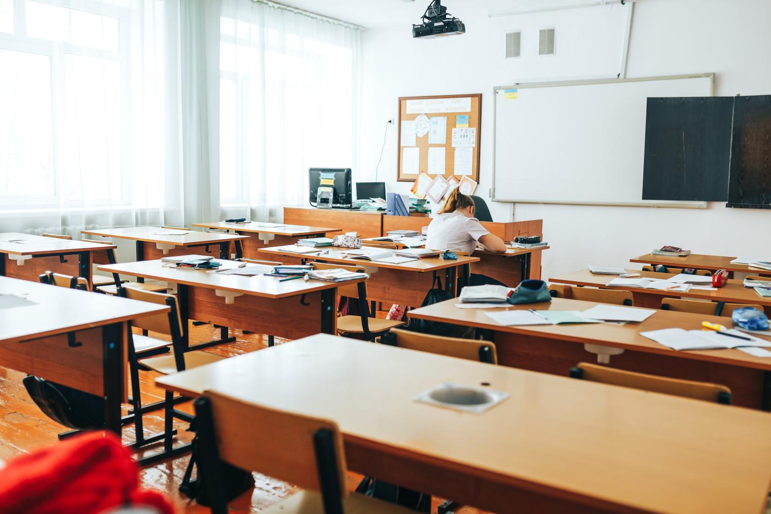 Classroom that is empty except for one student.