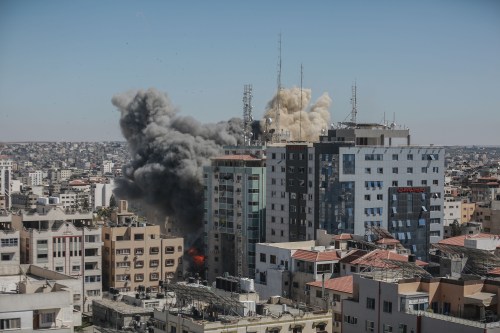 Smoke and flames rise after an Israeli air-strike hits at Al-Jalaa tower, which houses apartments and several media outlets, including The Associated Press and Al Jazeera, amid the escalating flare-up of Israeli-Palestinian violence.