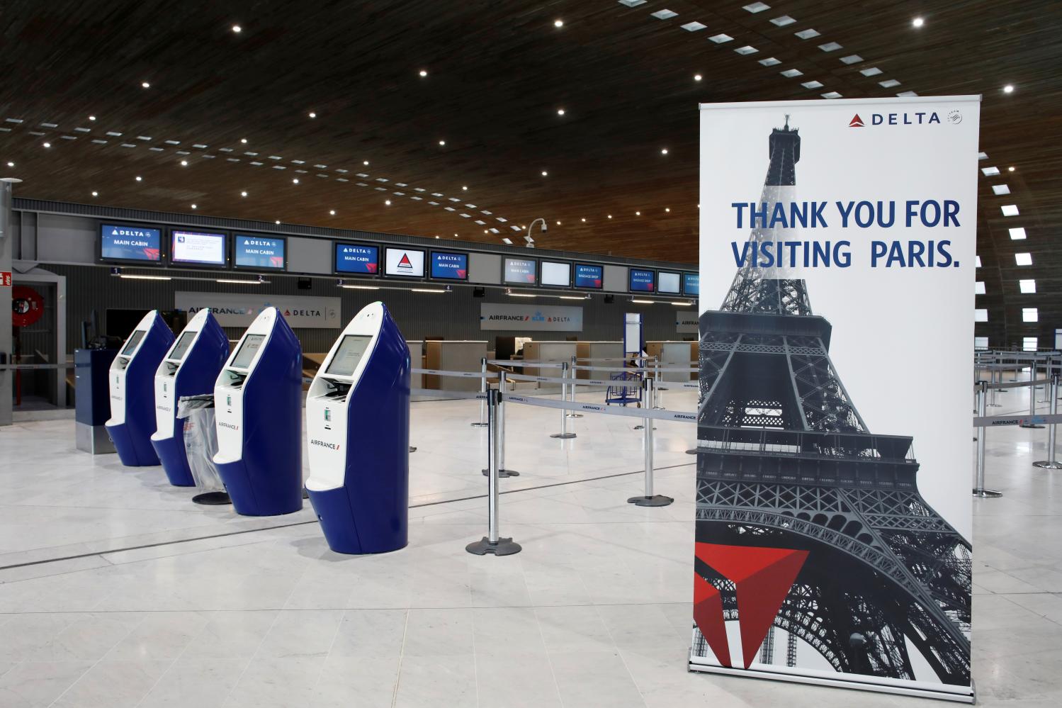 FILE PHOTO: American airlines company Delta registration desks are deserted at Paris Charles de Gaulle airport, following the coronavirus disease (COVID-19) outbreak, in Roissy-en-France, France March 16, 2020. REUTERS/Benoit Tessier/File Photo