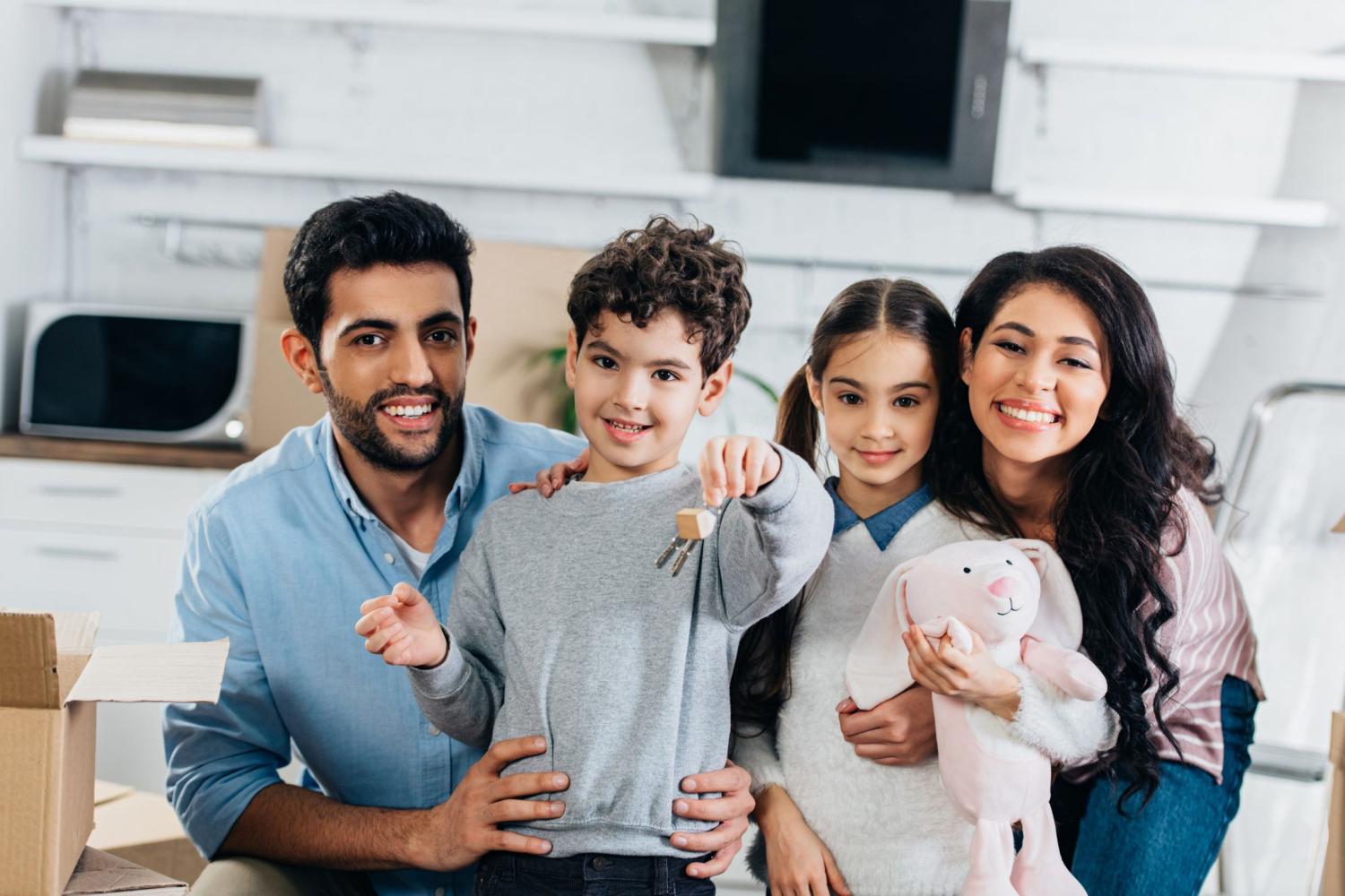 A family smiles in their new home.