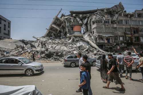 Palestinians inspect damaged buildings that were hit by Israeli airstrikes during the recent military conflict between Israel and the Palestinian enclave controlled by Hamas. Israel and Hamas have reached an agreement on the ceasefire after days of fighting in which around 230 Palestinians were killed in Israeli airstrikes and 12 people in Israel were killed by rocket fire from the Gaza Strip.