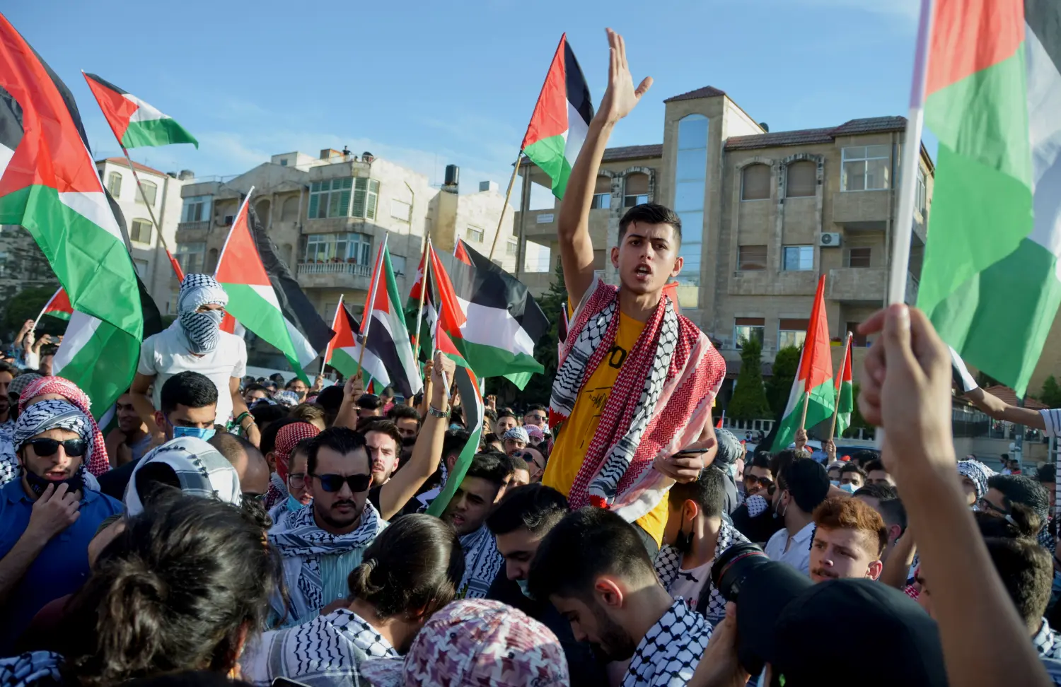 A demonstrator gestures during a protest to express solidarity with the Palestinian people, near the Israeli embassy in Amman, Jordan May 16, 2021. REUTERS/Muath Freij