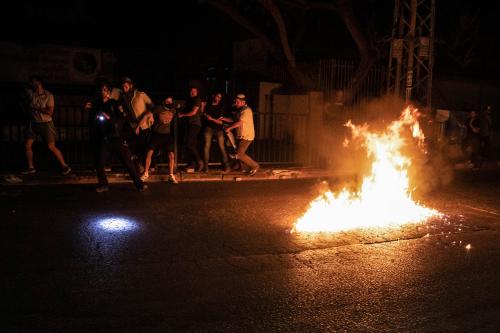 Molotov cocktails are thrown by Arabs at Jewish right-wing protesters during clashes amid a night-time curfew in the mixed Israeli-Arab city of Lod.
