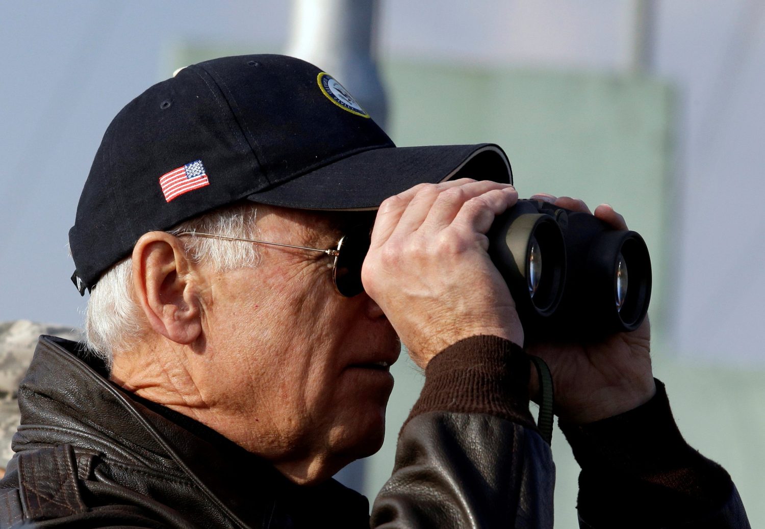 FILE PHOTO: U.S. Vice President Joe Biden looks through binoculars to see North Korea from Observation Post Ouellette during a tour of the Demilitarized Zone (DMZ), the military border separating the two Koreas, in Panmunjom, December 7, 2013. REUTERS/Lee Jin-man/Pool/File Photo