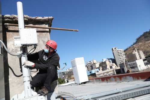A worker from a telecommunications company inspects a 5G technology device connected to an experimental 5G network, in Santiago, Chile March 22, 2021. REUTERS/Ivan Alvarado