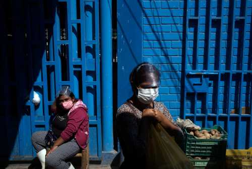 Hellen Nanez, who lost 13 relatives to the coronavirus disease (COVID-19) and whose father is being treated for COVID-19 in the Intensive Care Unit, shops ingredients to make handmade soap for sale, in Pisco, Peru, May 8, 2021. Picture taken May 8, 2021. REUTERS/Alessandro Cinque