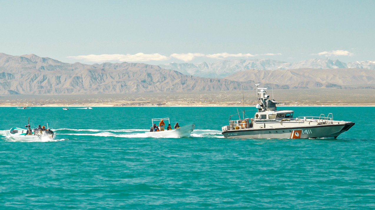 A Mexican Navy vessel is seen next to masked men on skiffs fishing illegally inside the Vaquita Refuge, a UNESCO World Heritage Site located in Mexico’s Upper Gulf of California, off San Felipe, Baja California, Mexico March 3, 2020 in this picture released by the Sea Shepherd. Sea Shepherd/Handout via REUTERS   ATTENTION EDITORS - THIS IMAGE HAS BEEN SUPPLIED BY A THIRD PARTY. MANDATORY CREDIT SEA SHEPHERD.