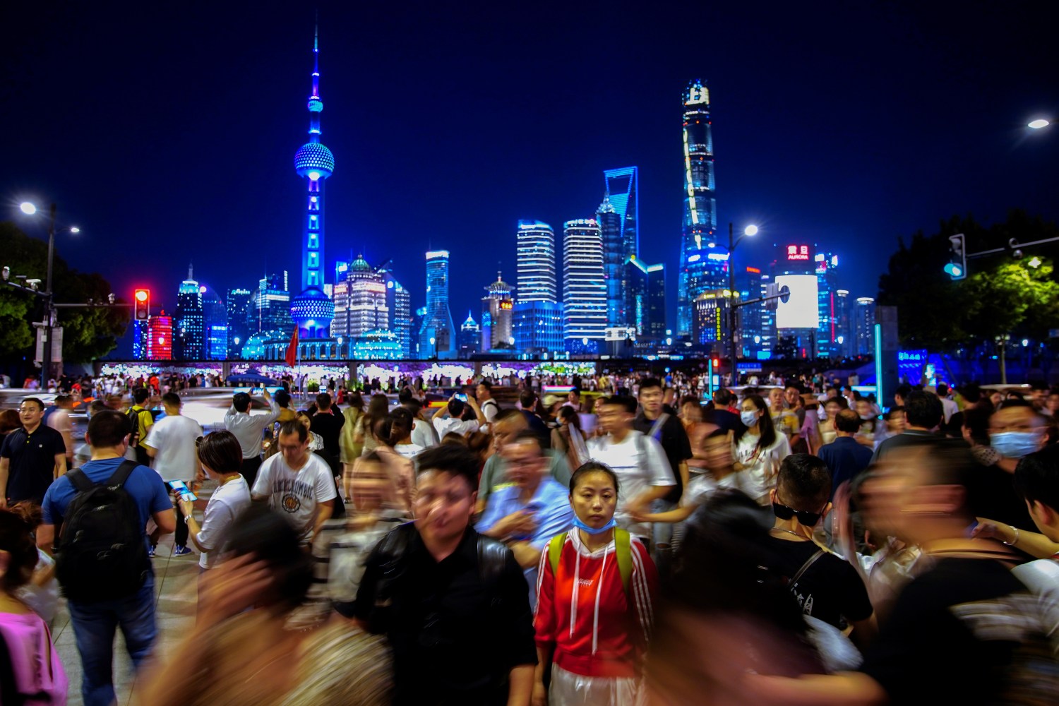 People walk along near the Bund, in front of Lujiazui financial district of Pudong, following the outbreak of the coronavirus disease (COVID-19), in Shanghai, China May 10, 2021. REUTERS/Aly Song