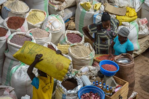 HUYE, RWANDA - SEPTEMBER 2019: People buying and selling in Huye market on September 16, 2019 in Huye, Rwanda.