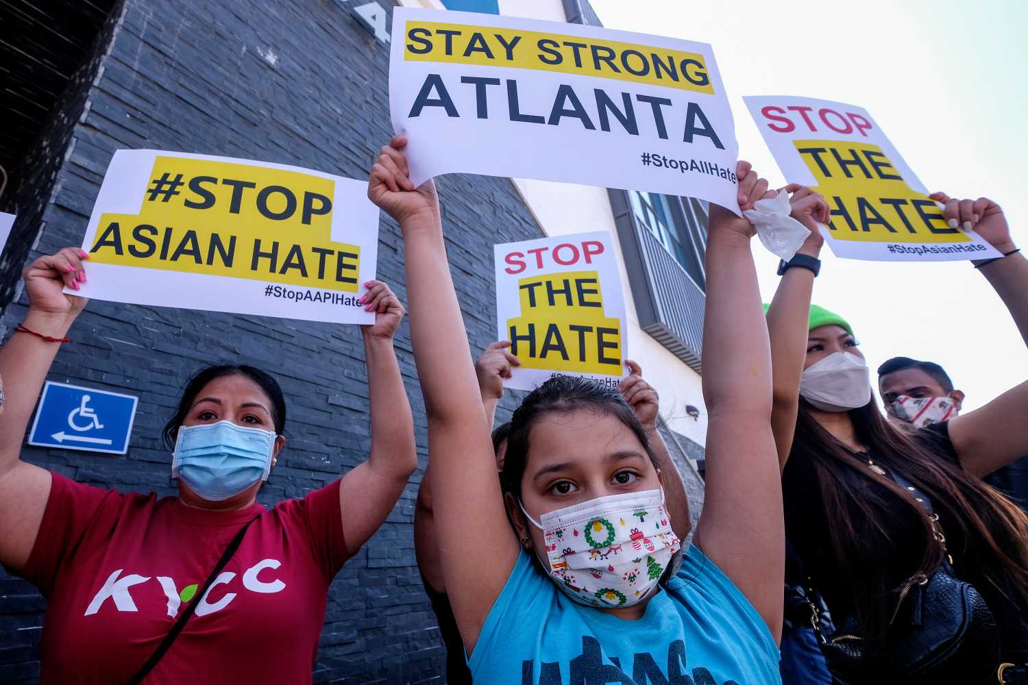 Melanie Bolanos, 9, holds a sign to protest hate crimes committed against Asian-American and Pacific Islander communities ahead of a car caravan in Koreatown on March 19, 2021 in Los Angeles.