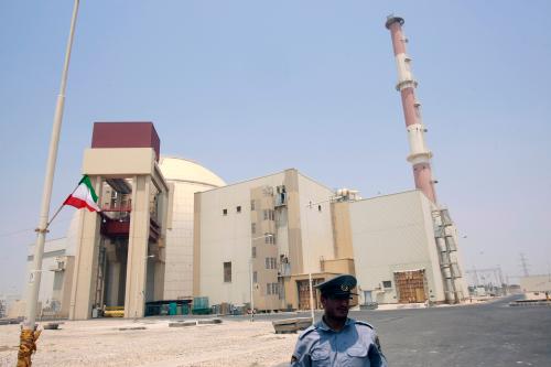 EDITORS' NOTE: Reuters and other foreign media are subject to Iranian restrictions on leaving the office to report, film or take pictures in Tehran.A security official stands in front of the Bushehr nuclear reactor, 1,200 km (746 miles) south of Tehran, August 21, 2010. Iran began fuelling its first nuclear power plant on Saturday, a potent symbol of its growing regional sway and rejection of international sanctions designed to prevent it building a nuclear bomb. REUTERS/Raheb Homavandi (IRAN - Tags: POLITICS ENERGY)