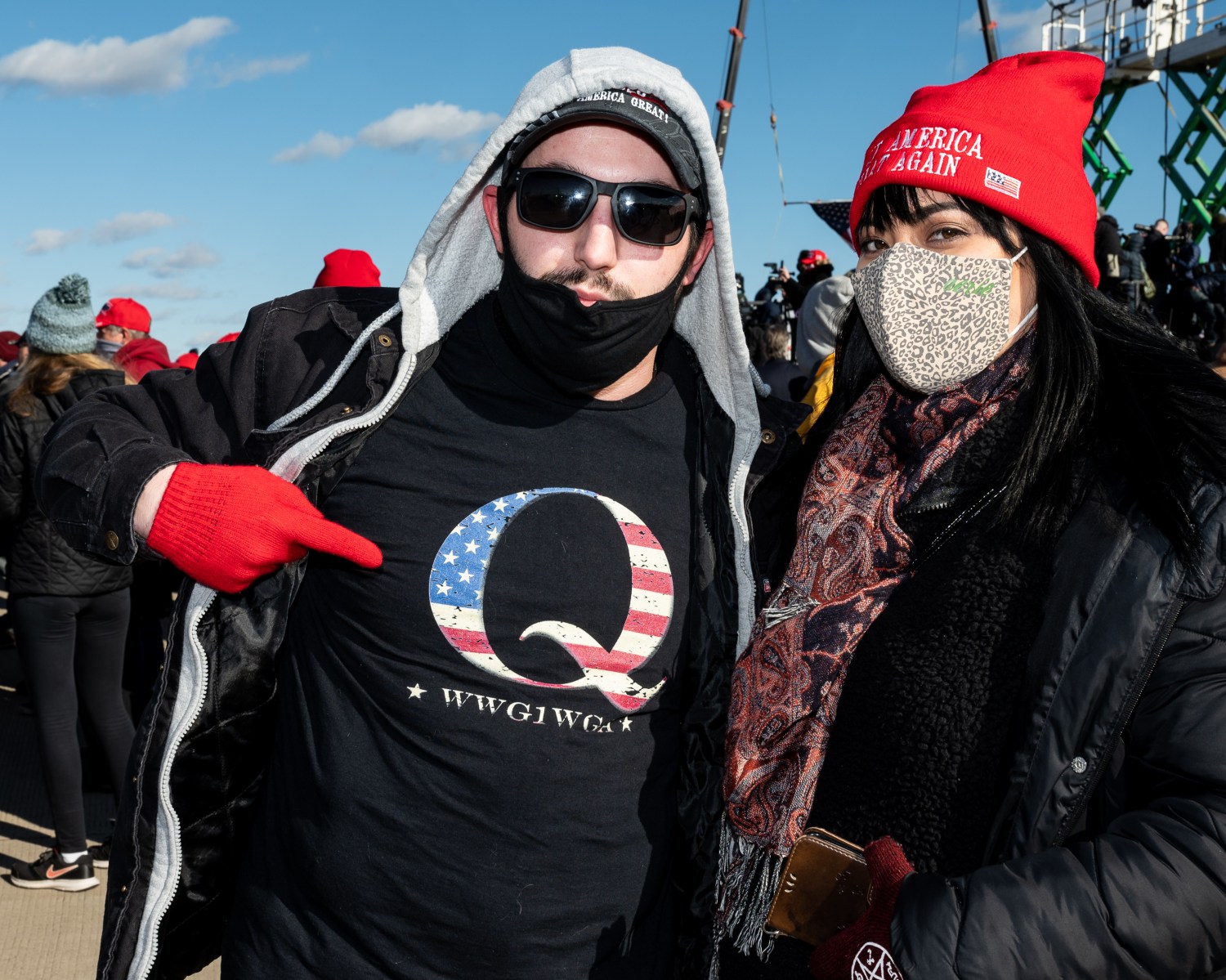 A man wearing a shirt with a QAnon logo attends a 2020 rally in support of Donald Trump's re-eleciton.