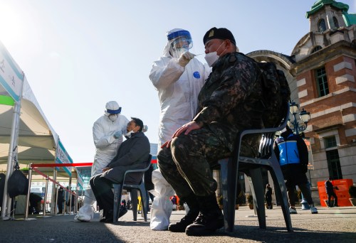 A South Korean soldier undergoes a coronavirus disease (COVID-19) test at a coronavirus testing site which is temporarily set up at a railway station in Seoul, South Korea, December 15, 2020. REUTERS/Kim Hong-Ji     TPX IMAGES OF THE DAY