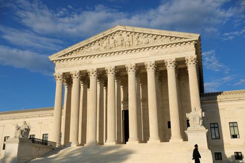 A police officer walks in front of the United States Supreme Court Building in Washington, D.C., U.S., May 13, 2021. REUTERS/Andrew Kelly