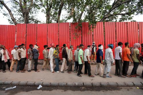 Homeless people wait in a queue to receive free food during a lockdown imposed to curb the spread of the coronavirus disease (COVID-19),in New Delhi. (Photo by Amarjeet Kumar Singh / SOPA Imag/Sipa USA)No Use Germany.