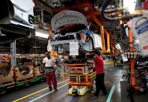 FILE PHOTO: General Motors assembly workers connect a battery pack underneath a partially assembled 2018 Chevrolet Bolt EV vehicle on the assembly line at Orion Assembly in Lake Orion, Michigan, U.S., March 19, 2018. REUTERS/Rebecca Cook/File Photo