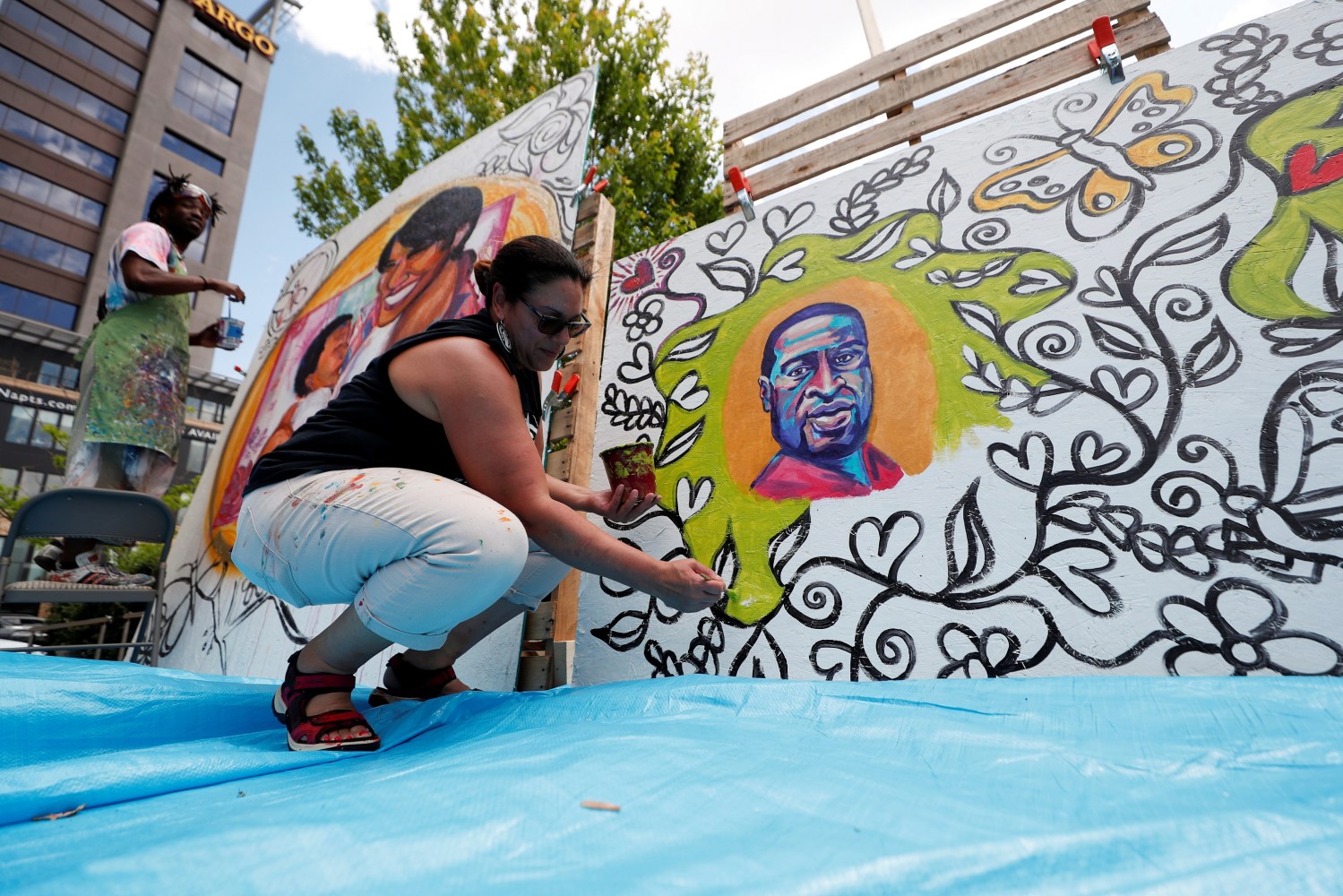 Melodee Strong paints a mural at a Celebration of Life festival in honor of George Floyd, on the first anniversary of his death, in Minneapolis, Minnesota, U.S. May 25, 2021. REUTERS/Eric Miller