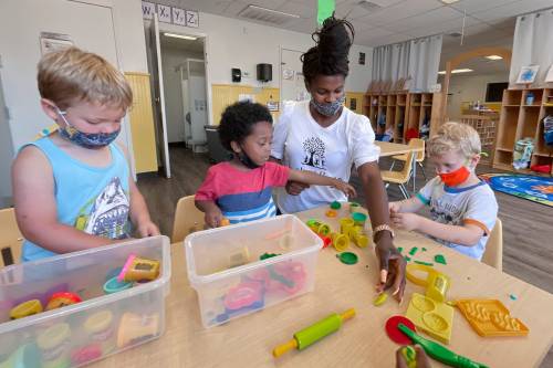 Pre-school teacher LaMyia Hayes works (left to right) with Macsen Pope, Arrian Haynes and William Duncan at Youth Village  s new location on Anchors Street.Youth Village 0573