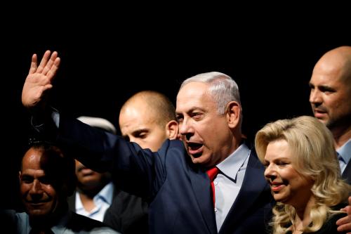 Israeli Prime Minister Benjamin Netanyahu and his wife Sara react to his supporters during an event by his Likud Party.