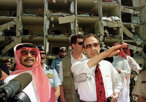 US Secretary of Defence William Perry (R), accompanied by the Saudi Ambassador to the US., Prince Bandar bin Sultan bin Abd al-Aziz Al Saud (L), survey the bomb site outside the heavily damaged apartment at the Khobar Towers housing complex for U.S. military personnel in Dhahran June 29. Nineteen American servicemen were killed, and several hundred others were injured when a bomb exploded outside the bulding on June 25.