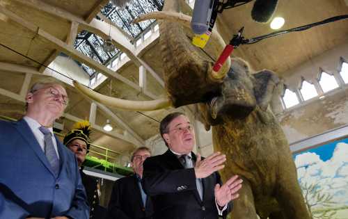 Reiner Haseloff (CDU, l), Minister President of Saxony-Anhalt, stands next to Armin Laschet (CDU), Minister President of North Rhine-Westphalia and candidate for the chancellorship of the CDU/CSU, in front of a model of a forest elephant that lived 200,000 years ago at the Pfännerhall exhibition centre. A new state parliament will be elected in Saxony-Anhalt on 06.06.2021.