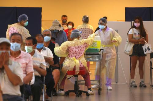 A medical worker administers a dose of the AstraZeneca vaccine against the coronavirus disease (COVID-19) to a man during a vaccination session for elderly people over 75 years old, at a stadium in New Taipei City, Taiwan June 25, 2021. REUTERS/Ann Wang