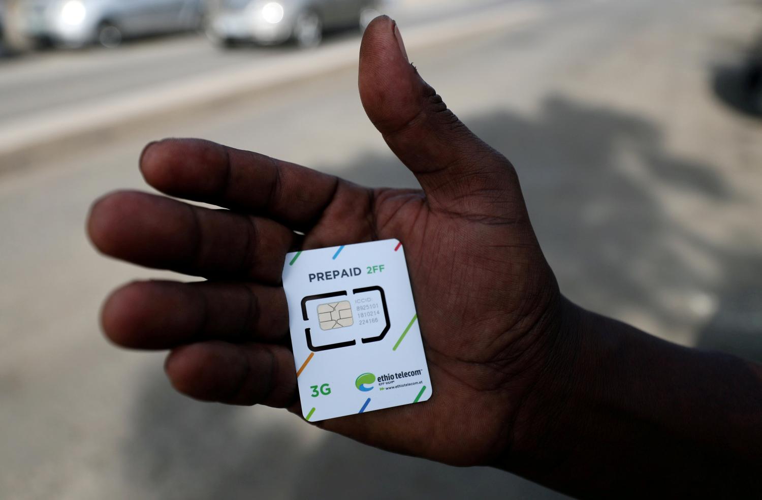 FILE PHOTO: A customer holds a 3G prepaid sim card after buying the service from an Ethio-Telecom shop in Addis Ababa, Ethiopia, November 12, 2019. REUTERS/Tiksa Negeri/File Photo