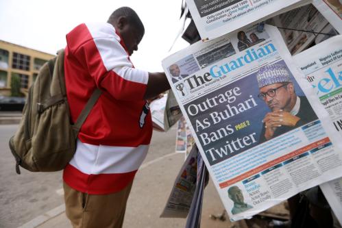 A man reads a newspaper at a newsstand in Abuja, Nigeria June 5, 2021. REUTERS/Afolabi Sotunde