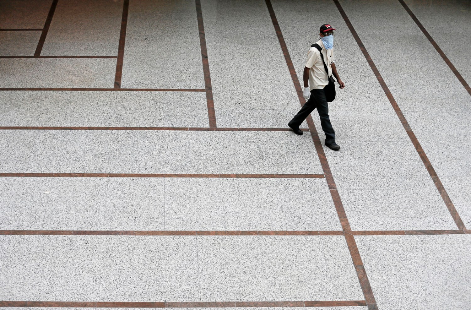 A man walks inside the World Trade Center after the government announced that private and state companies will reopen their offices after almost two months of lockdown amidst concerns about the spread of coronavirus disease (COVID-19) in Colombo, Sri Lanka May 11, 2020. REUTERS/Dinuka Liyanawatte