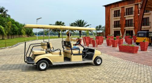 Driver of a Golf Club Car drives to the main building of the Aqua Safari Resort. Relax at a luxury beach resort. Modern architecture. Travel and vacation in West Africa. Ghana, Volta, Ada – Jan14,2017