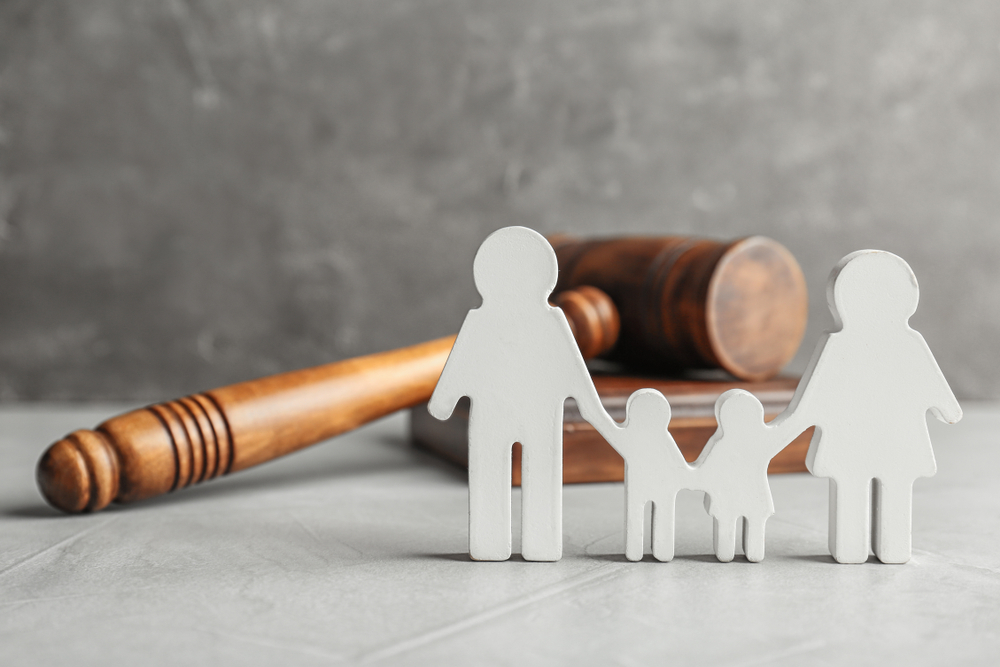 family cutout in front of a gavel